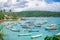 A lot of boats moored on standing and blue ocean