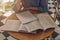 Lot of books on wood desk in modern cafe or library. Concept of research and searching answers in textbooks