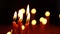 A lot of burning candles in the temple. The concept of religion, prayer and God. Close-up of the flame burning on the