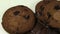 Lot of chip cake cookies with chocolate close-up tilting and Pieces of milk and dark chocolate