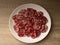 A lot of chopped salami that lies on a white plate, the plate lies