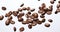 A lot of coffee beens flying on a white background