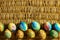 A lot of colorful Easter eggs is on the background of braided willow branches