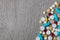 Lot of colorful medication and pills from above on grey wooden background. Copy space. Top view, frame. Painkillers, tablets, gene