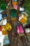 A lot of colorful painted birdhouses on the tree trunk