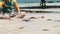 Lot of Colorful Starfish Lies on Sandy Beach near Boy in Shallow Water, Low Tide