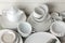 A lot of different dishes. Dinnerware. on a light concrete background. dishes for serving the table. various plates, bowls, and cu