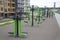 A lot of different fitness equipment made of metal on the Playground in the city outdoors.