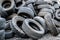 A lot of different old, dirty worn out car tires in a landfill