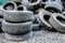 A lot of different old, dirty worn out car tires in a landfill