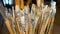 A lot of different paint brushes stand upright in vases. Professional equipment of the artist. Art Studio. Focus of the