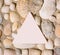 A lot of different sea shells arrangement with white triangle framed creative copy space