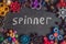 A lot of different spinners on a black background And the inscription spinner
