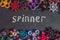 A lot of different spinners on a black background And the inscription spinner