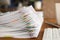 Lot of documents fastened with multicolored paper clips lying on table closeup