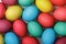 A lot of Easter multicolored eggs on a white table.Top view. Close-up