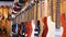Lot of electric guitars hanging in a music store. Shop musical instruments