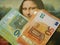 A lot of euro money against the background of an old painting Mona Liza La Gioconda from Leonardo Da Vinci, money for art