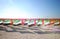 Lot of flags United Arab Emirates for the anniversary celebration on the beach. Sun ray.