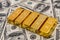 Lot of gold bars on dollar bills background. save money concept