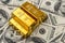 Lot of gold bars on dollar bills background. save money concept