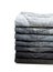 Lot of grey used jeans stacked in a pile isolated on white