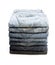 Lot of grey used women jeans stacked in a pile isolated on white