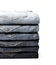 Lot of grey used women jeans stacked in a pile isolated on white