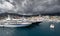 A lot of huge yachts are in port of Monaco at storm weather, mountain is on background, glossy board of the motor boat