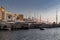 A lot of huge yachts are in port of Monaco at sunrise, Monte Carlo, mountain is on background, glossy board of the motor