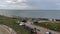 A lot of kitesurfers gathered on the beach near the sea, getting ready