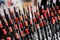 Lot of lip pencils testers on counter of make up store, vibrant red color