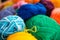 A lot of multi-colored balls of wool for knitting close-up.