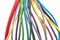 A lot of multi-colored electric wires on a white background. Solid wire with color insulation marked plus and minus