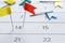 A lot of multi-colored pin flags on the calendar. Important date. Place for text.