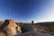 Lot of multicolor hot air balloons on blue clear sunlit sky and fairy chimneys rock formations at morning