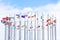 A lot of national flags of european countries on flagpoles abova blue sky. Concept