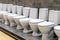 Lot of new white modern ceramic toilets bowls in a plumbing store