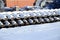 A lot of old rails and sleepers are stacked in a railway warehouse in winter. The concept of renewing a worn-out railway track