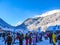 A lot of people in colorful clothes and various carnival costumes near the lift and slopes of the ski resort. Bulgaria, Bansko-