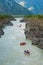 A lot of rafts and kayaks floating down a mountain river Katun. Mountain landscape.