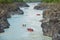 A lot of rafts and kayaks floating down a mountain river Katun. Mountain landscape.