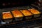 A lot of ready fresh bread in a bakery oven in a bakery. Fresh bread from Healthy and nutritious food.