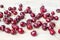 A lot of red berries of sweet cherry scattered on light wooden table close up, bunch of ripe cherry berries on white background