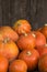 A lot of red ripe pumpkins on a old wooden background close up, holiday halloween. Pile of ripe pumpkins. Harvest autumn wallpaper