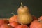 A lot of red ripe pumpkins on a old wooden green background close up, holiday halloween. Pile of ripe pumpkins. Harvest autumn