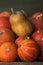 A lot of red ripe pumpkins on a old wooden green background close up, holiday halloween. Pile of ripe pumpkins. Harvest autumn