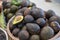 Lot of ripe Avocados on bowl, and one of avocado slice to show inside of fresh fruit