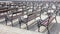 Lot of Rows of empty brown wooden benches