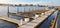 a lot of sea larges sitting and lying on the platform of the marina by the ocean and the sea gull